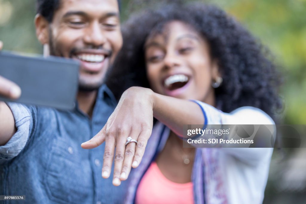 Young woman shows off engagement ring