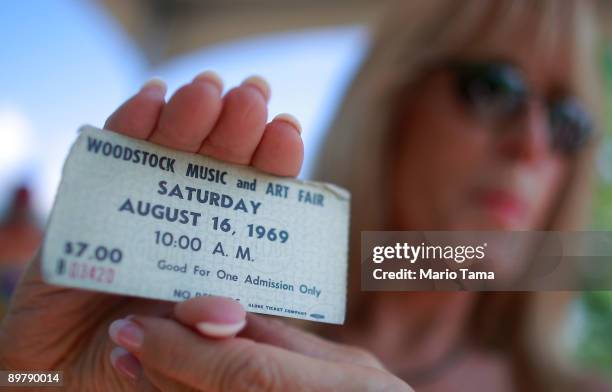 Janet Huey holds her original concert ticket as the 40th anniversary of the Woodstock music festival approaches August 14, 2009 in Bethel, New York....