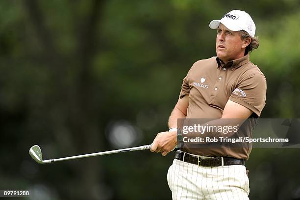 Phil Mickelson hits his tee shot on the 14th hole during the continuation of the final round of the 109th U.S. Open on the Black Course at Bethpage...