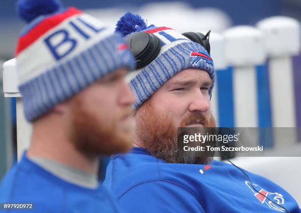 Kyle Williams of the Buffalo Bills sits beside Nick O'Leary in the foreground as they prepare for their warmup before their NFL game against the...