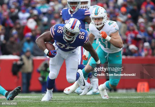 Charles Clay of the Buffalo Bills runs with the ball as he is pursued by Kiko Alonso of the Miami Dolphins during NFL game action at New Era Field on...