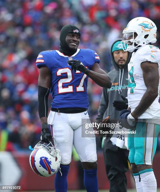 Tre'Davious White of the Buffalo Bills talks to Jarvis Landry of the Miami Dolphins during a break in the action of their NFL game at New Era Field...