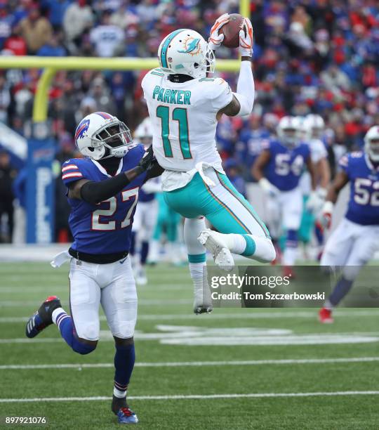 DeVante Parker of the Miami Dolphins catches a pass during NFL game action as Tre'Davious White of the Buffalo Bills tries to defend at New Era Field...