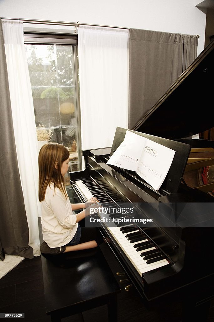 Girl practicing on piano