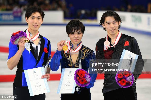 Keiji Tanaka , Shoma Uno and Takahito Mura of Japan pose with their medals after competing in the men free skating during day four of the 86th All...