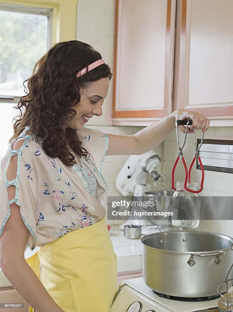 Woman sterilizing jars