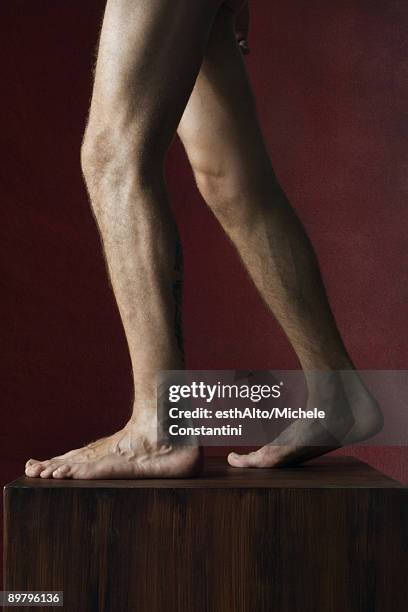 man's bare legs on pedestal, side view - jambes hommes photos et images de collection