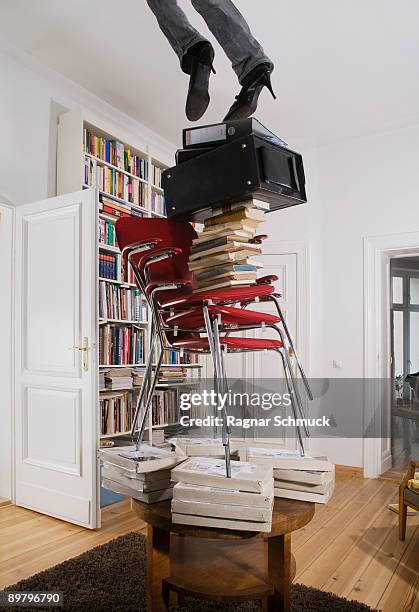 a woman falling off a stack of objects, low section - ignorancia fotografías e imágenes de stock