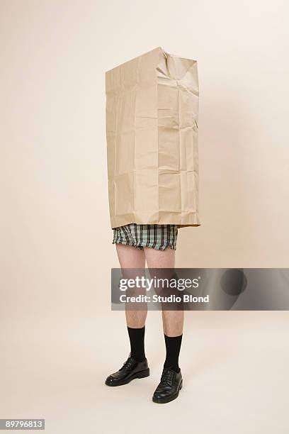a semi-dressed man wearing a large paper bag - pants down bildbanksfoton och bilder