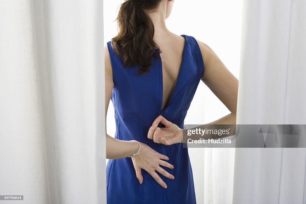 A woman trying on a dress