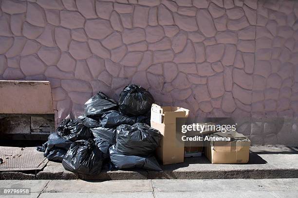 boxes and bags of rubbish on a sidewalk - bin bag stock pictures, royalty-free photos & images