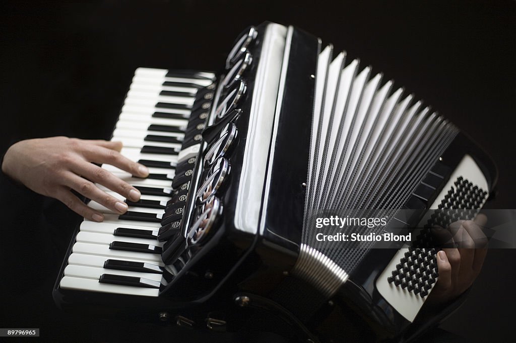 Human hands playing an accordion