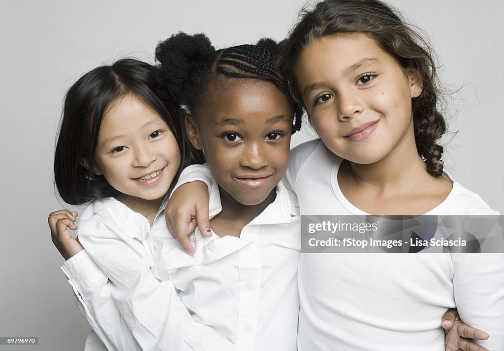 Portrait of three girls embracing each other