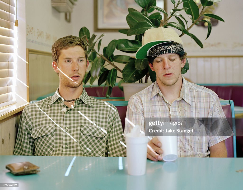 Two young men sitting in a diner