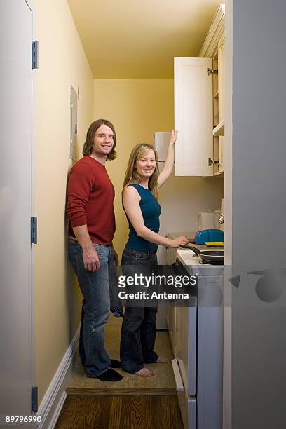 portrait of a young couple standing in a kitchen - minute dating stock pictures, royalty-free photos & images