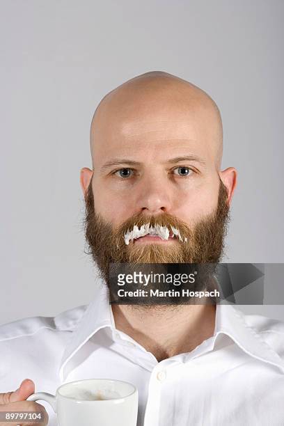 a man with a milk moustache on his real mustache - usar la boca fotografías e imágenes de stock