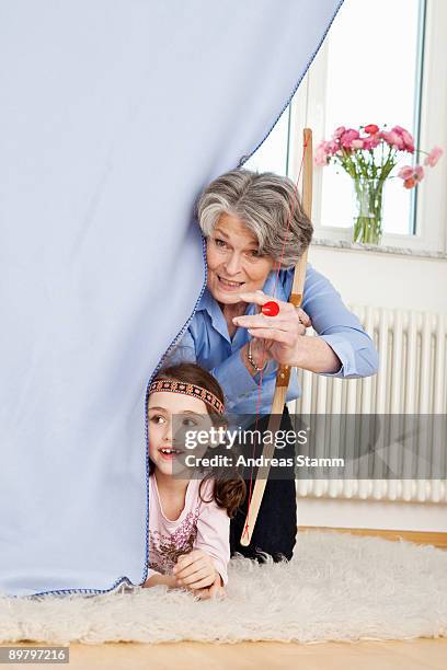 a grandmother and her granddaughter playing make believe - indiandräkt bildbanksfoton och bilder