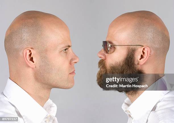 a digital composite of a man looking at himself - side profile face to face stock-fotos und bilder