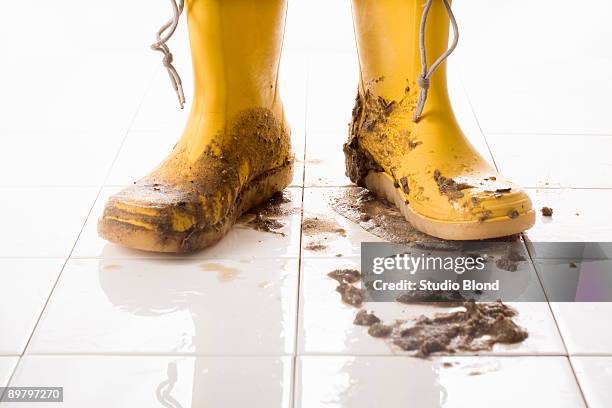 a pair of muddy rubber boots - boots stock pictures, royalty-free photos & images