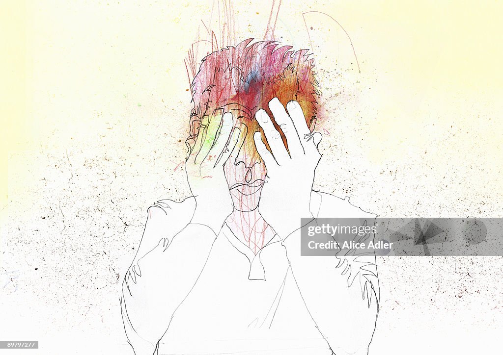 A man holding his face in his hands