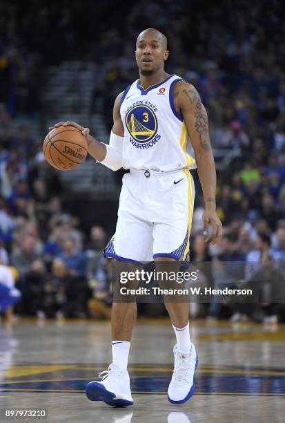 David West of the Golden State Warriors dribbles the ball against the Dallas Mavericks during an NBA basketball game at ORACLE Arena on December 14,...
