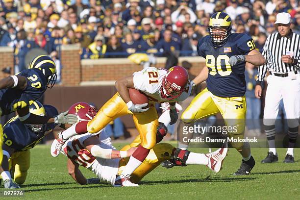 Running back Marion Barber of the Minnesota Golden Gophers looks for room to run past cornerback Marlin Jackson of the Michigan Wolverines during the...