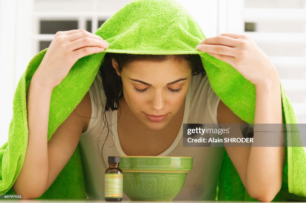 Woman inhaling over a bowl