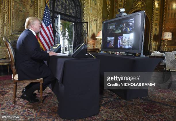 President Donald J. Trump participates in a video teleconference call with military members on Christmas Eve in Palm Beach, Florida on December 24,...