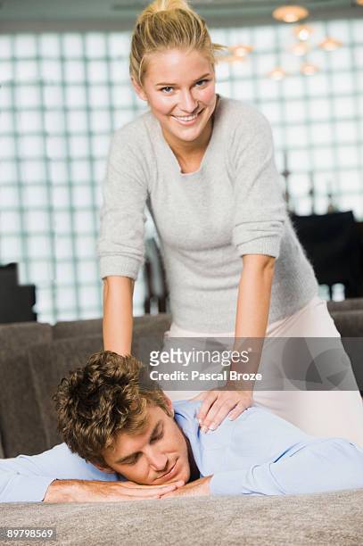 woman massaging a man's shoulders - girlfriend massage stock pictures, royalty-free photos & images