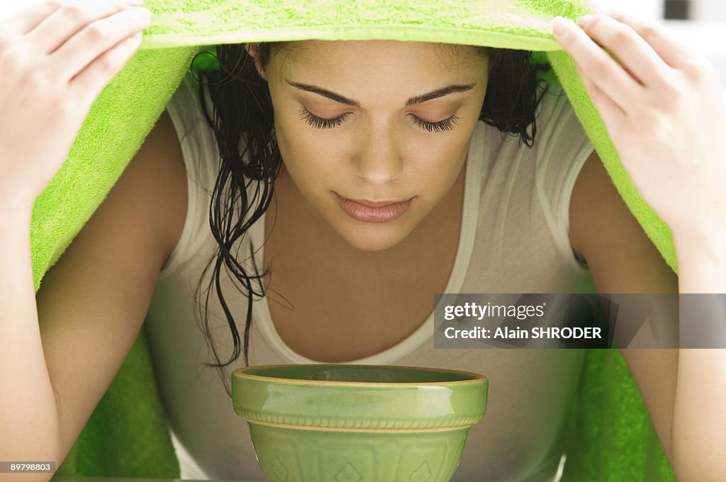 Woman inhaling over a bowl