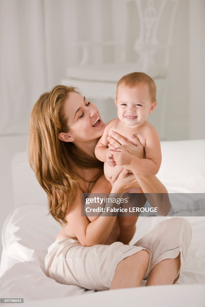 Woman carrying her daughter