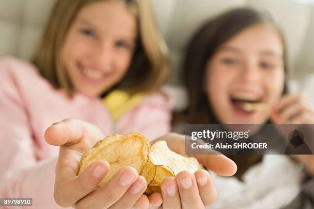 girl holding potato chips in her hands - family eating potato chips stock pictures, royalty-free photos & images