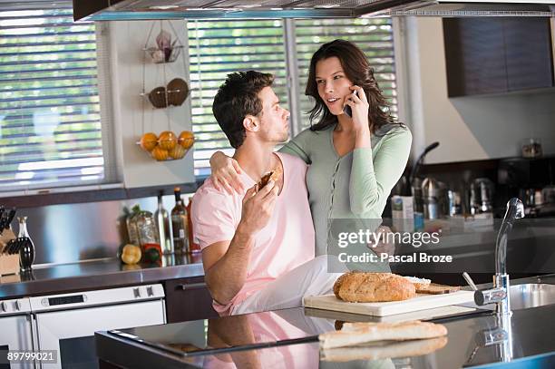 couple in the kitchen - eating brown bread stock pictures, royalty-free photos & images