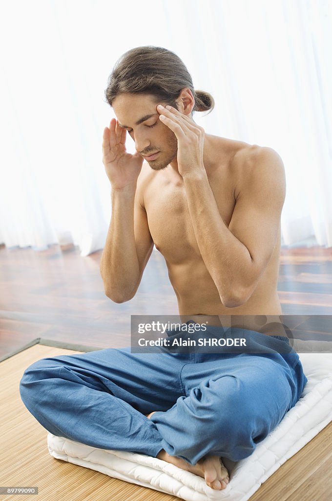 Man massaging his temple