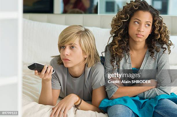 teenage boy watching television with a girl sitting beside him - alter tv stock pictures, royalty-free photos & images