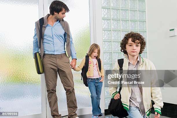 man with his children entering a house - denim arrivals stock pictures, royalty-free photos & images