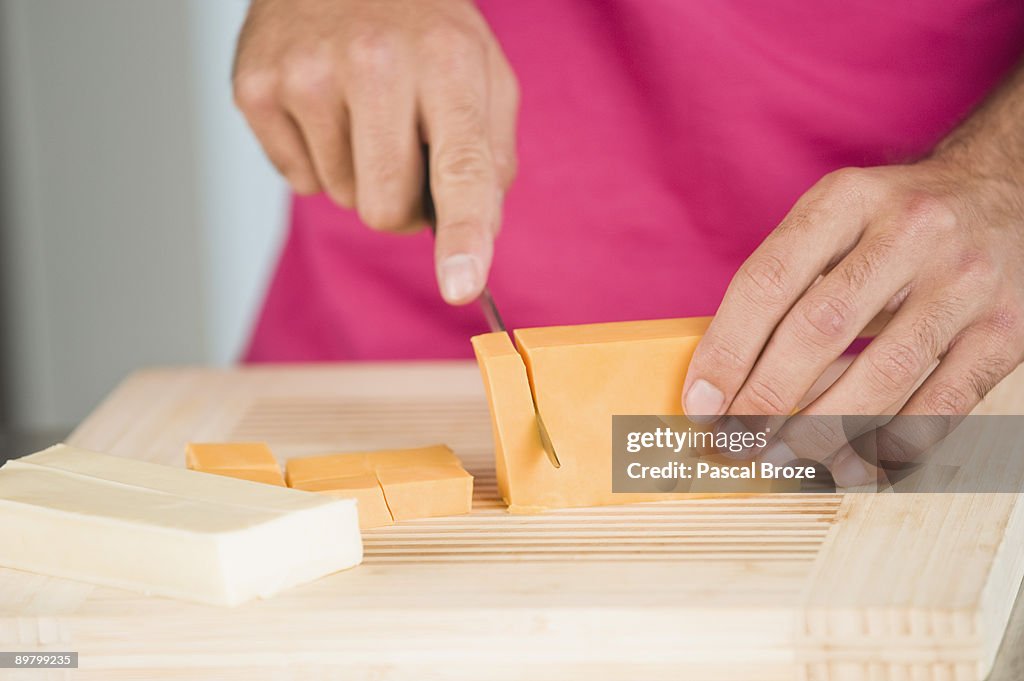 Woman cutting cheese slices