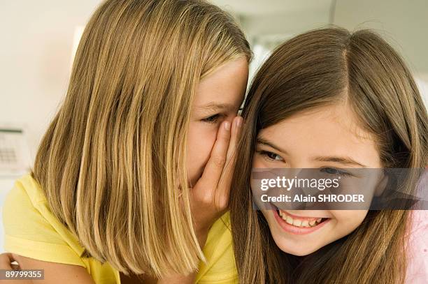 girl whispering to her sister - 12 ears stock pictures, royalty-free photos & images