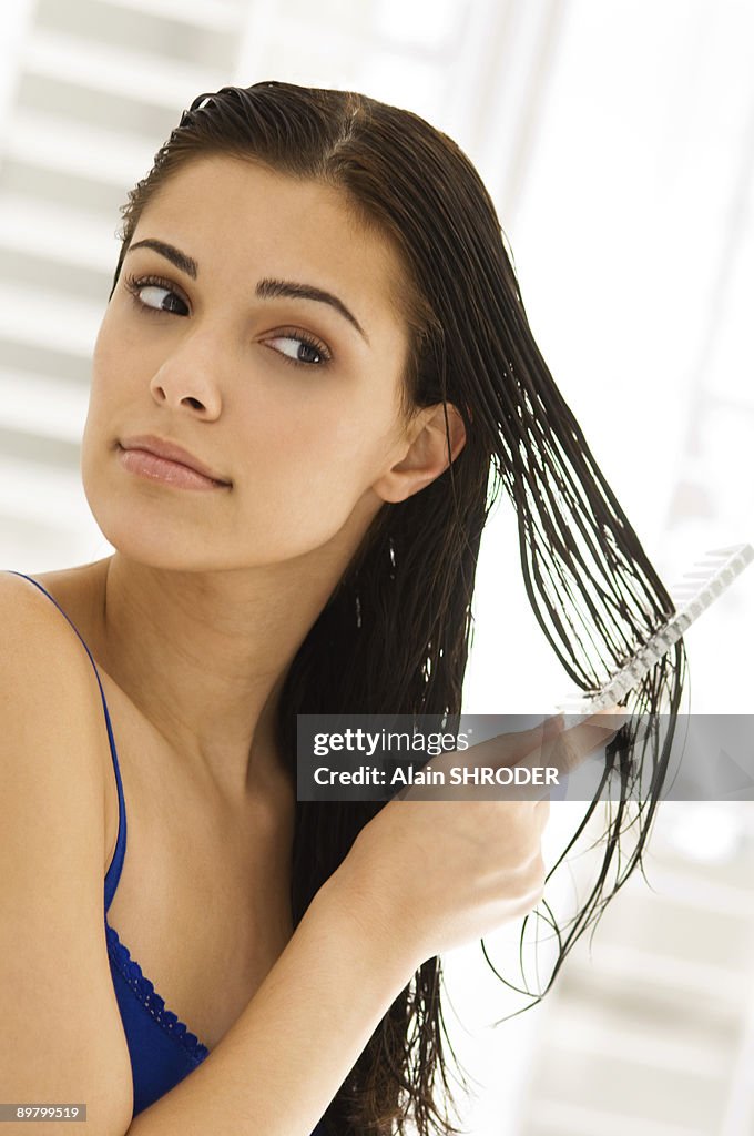 Close-up of a woman combing her hair