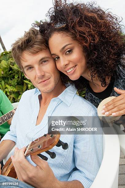 portrait of a couple playing musical instruments - conga tambor sencillo fotografías e imágenes de stock