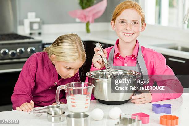two girls cooking food in the kitchen - measuring jug stock pictures, royalty-free photos & images