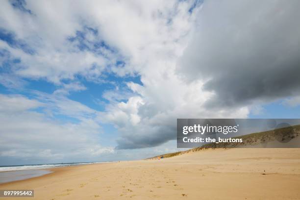 low angle view of beach, dunes and cloudy sky - cap ferret stock pictures, royalty-free photos & images