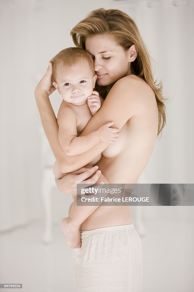 Woman carrying her daughter