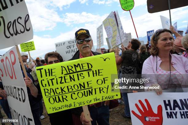 Peter Drowne of Big Fork, Montana protests outside a town hall-style meeting attended by U.S. President Barack Obama in a hangar at Gallatin Field...