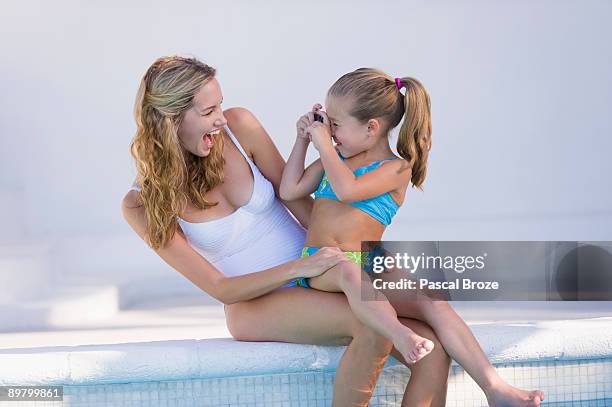 girl taking a picture of her mother - see through swimsuit fotografías e imágenes de stock