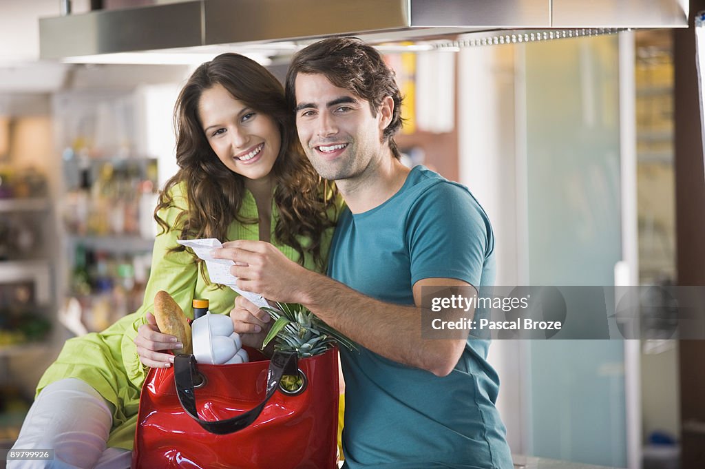 Couple holding a shopping bill