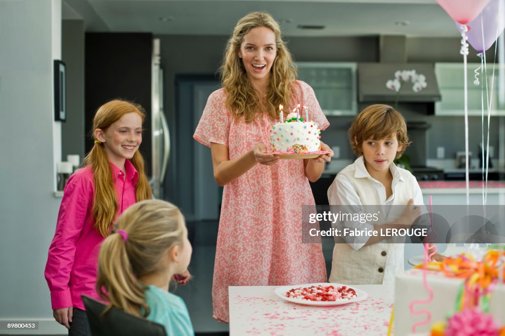 Woman with three children at a birthday party