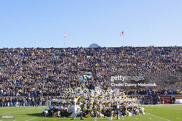 The Michigan Wolverines marching band poses at the fifty yard line before the Big Ten Conference football game against the Minnesota Golden Gophers...