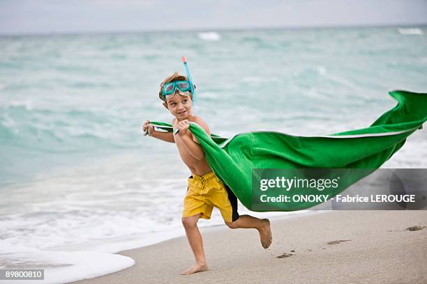 boy wearing a scuba mask and running on the beach - bermuda snorkel stock pictures, royalty-free photos & images