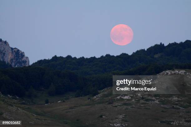 pink full moon over campo imperatore, abruzzo, italy, europe. - pink moon stock-fotos und bilder